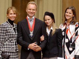 BRITAIN'S STING STANDS WITH MEMBERS OF HIS FAMILY AFTER RECEIVING HIS CBE AT BUCKINGHAM PALACE IN LONDON.