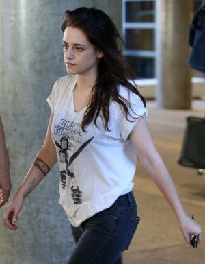 Kristen Stewart at LAX - new fish tattoo or pens on a plane?