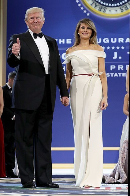 WASHINGTON, DC - JANUARY 20: U.S. President Donald Trump (L) and first lady Melania Trump thank guests during the inaugural Armed Forces Ball at the National Building Museum January 20, 2017 in Washington, DC. The ball is part of the celebrations following Trump's inauguration. (Photo by Chip Somodevilla/Getty Images)